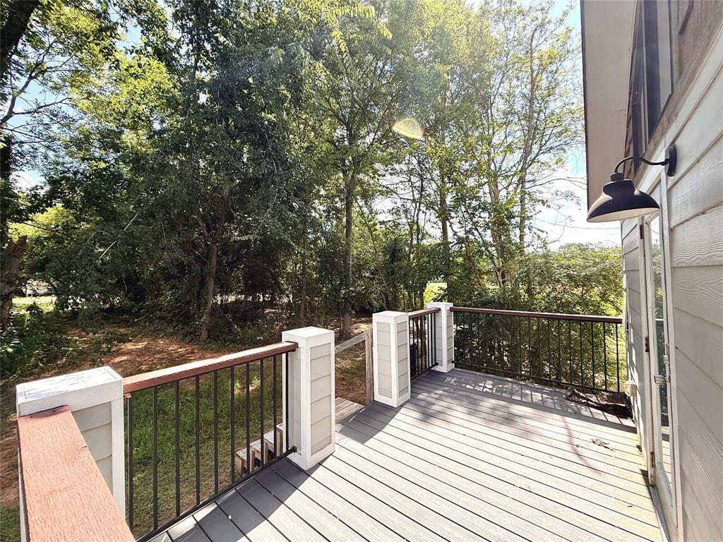 3235 County Road Cookville, TX 75558 - Photo 16 of 37 a view of a balcony with wooden floor and fence