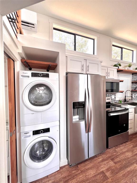 3235 County Road Cookville, TX 75558 - Photo 18 of 37 a kitchen with refrigerator a washer and dryer