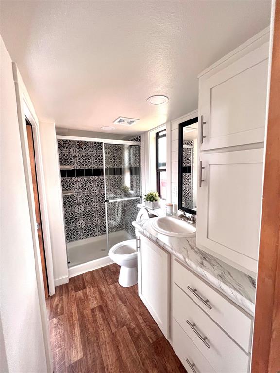 3235 County Road Cookville, TX 75558 - Photo 19 of 37 a bathroom with a sink a toilet and shower