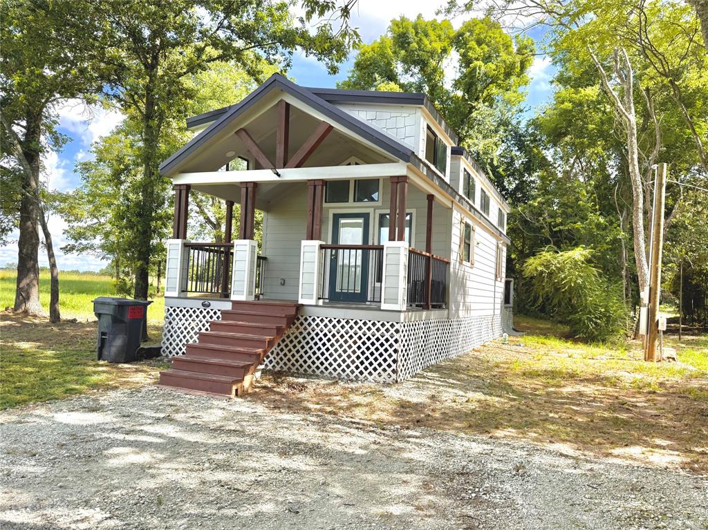 3235 County Road Cookville, TX 75558 - Photo 7 of 37 a front view of a house with a yard