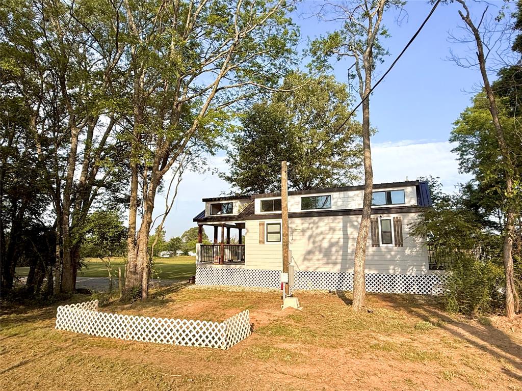 3235 County Road Cookville, TX 75558 - Photo 10 of 37 a front view of a house with a yard