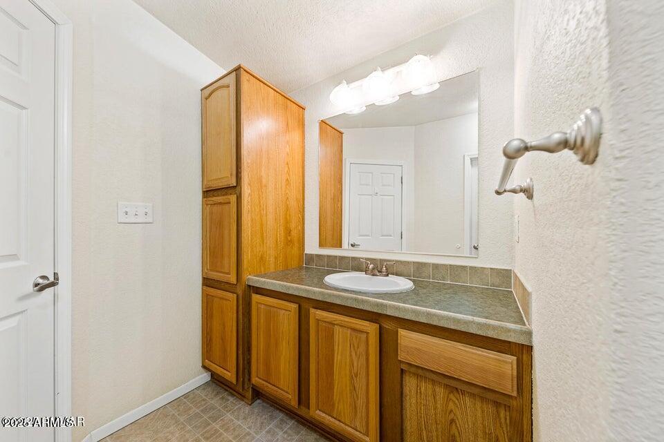 2421 West Thornton Road Show Low, AZ 85901 - Photo 35 of 48 a bathroom with a granite countertop sink and a mirror