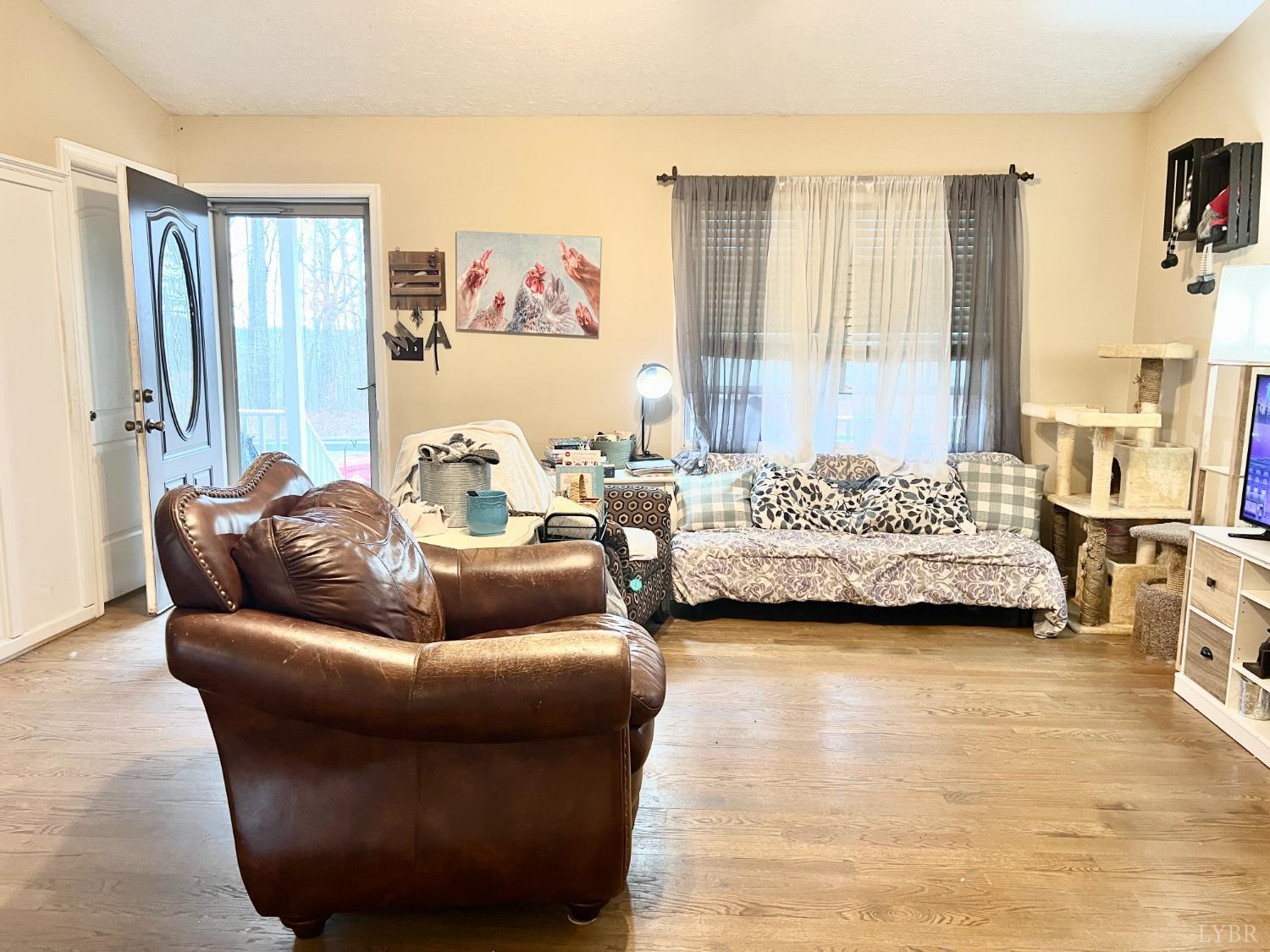 499 Reedy Spring Road Spout Spring, VA 24593 - Photo 20 of 66 a living room with furniture and a large window