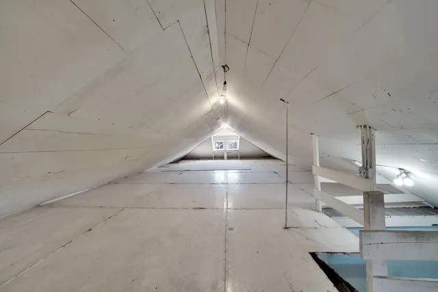 a view of a kitchen with a sink and chandelier fan