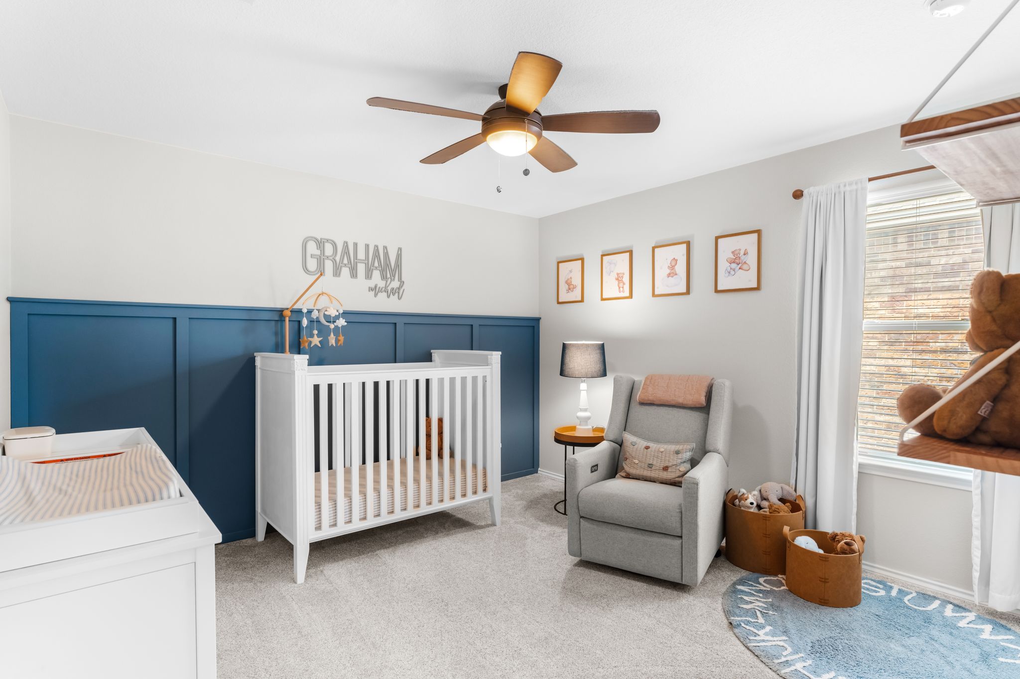 1133 Yellow Iris Road Leander, TX 78641 - Photo 23 of 37 Brightly lit room featuring a partial accent wall with wainscoting, light-toned carpet, and a ceiling fan with integrated lighting