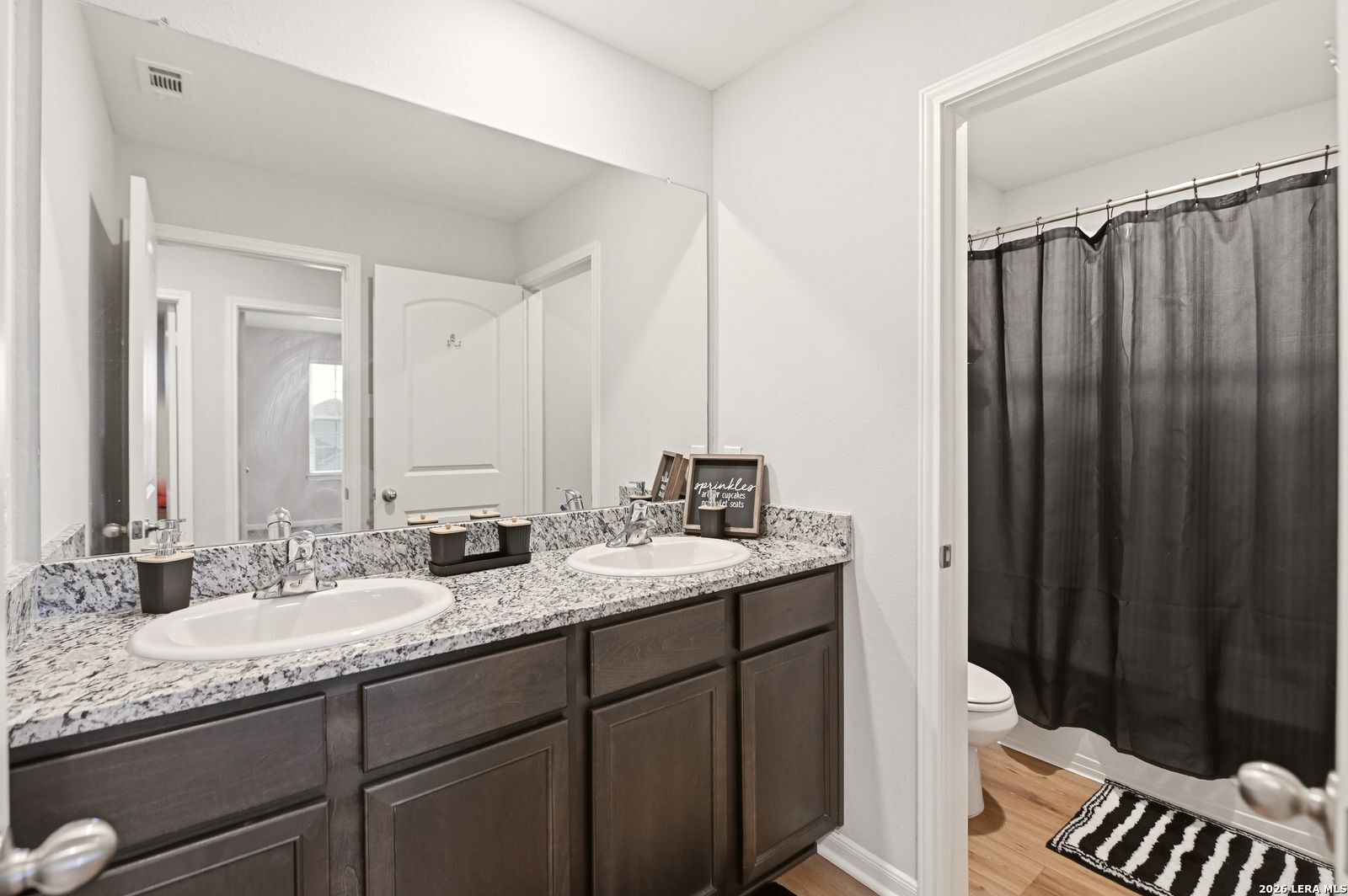 9123 Bennett Forest Converse, TX 78109 - Photo 15 of 19 a bathroom with a granite countertop sink and a mirror