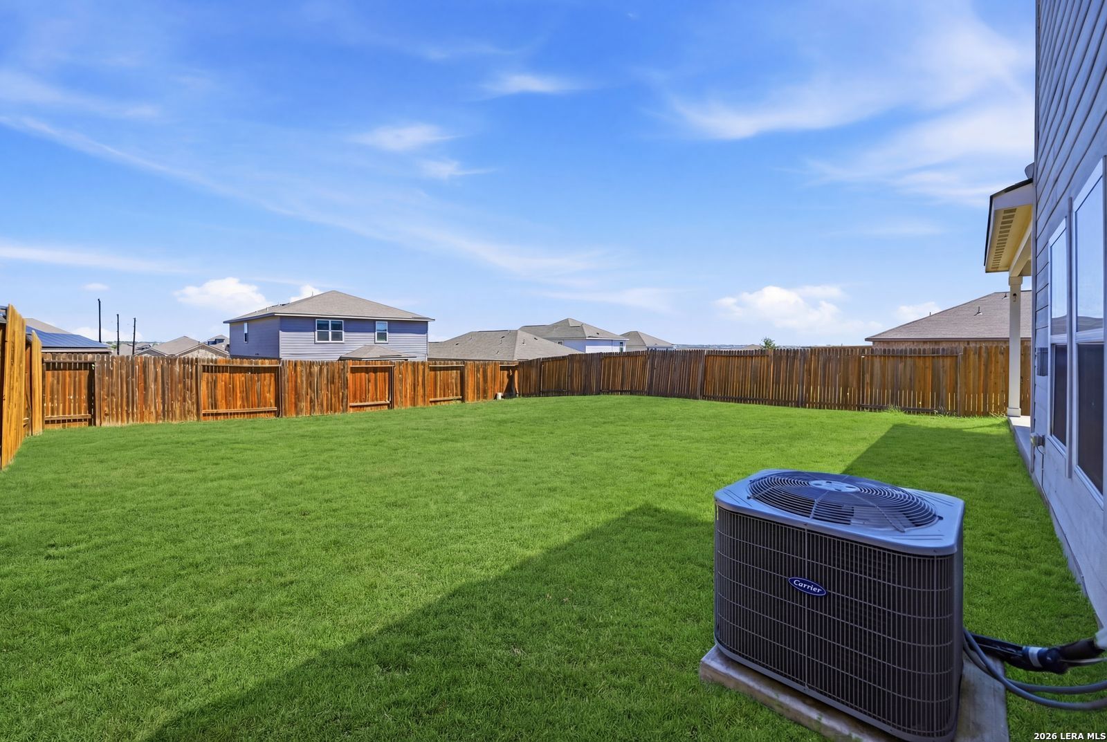 9123 Bennett Forest Converse, TX 78109 - Photo 18 of 19 a view of a big yard with table and chairs with wooden fence