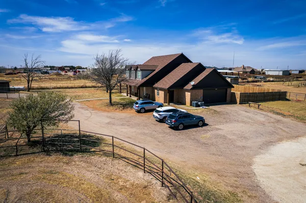 a spacious bathroom with a granite countertop sink a mirror and a shower