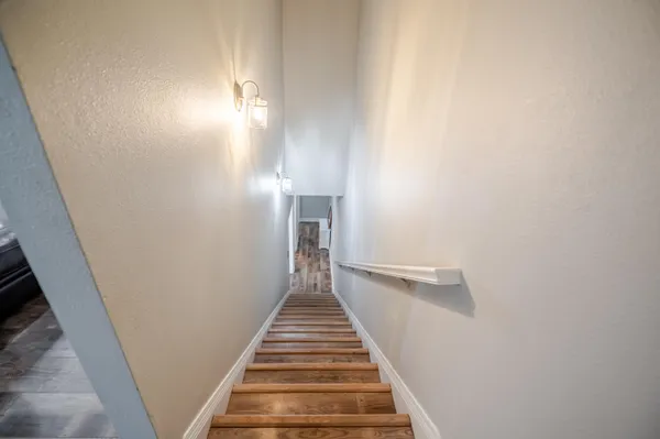 a kitchen with stainless steel appliances granite countertop a sink stove and wooden floor