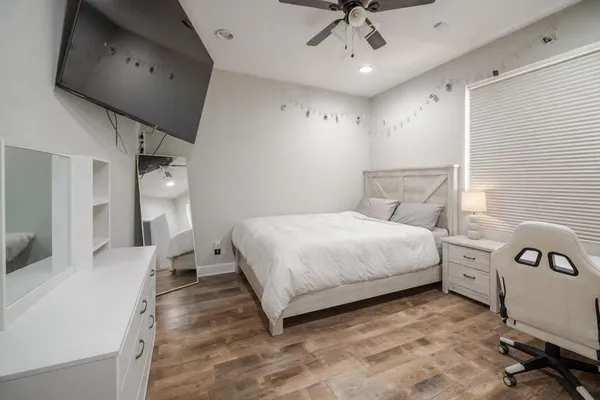 a bedroom with a bed a desk and chair