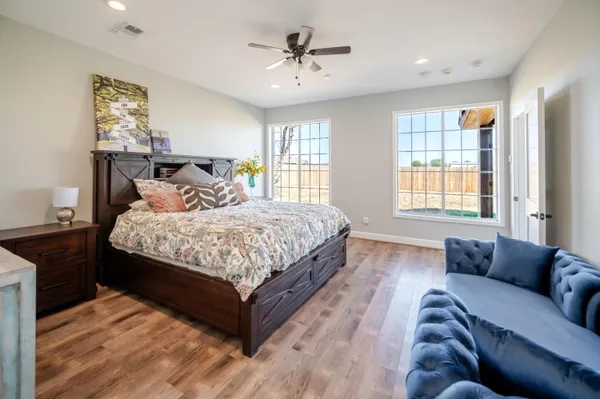 a view of a hallway with wooden floor and closet