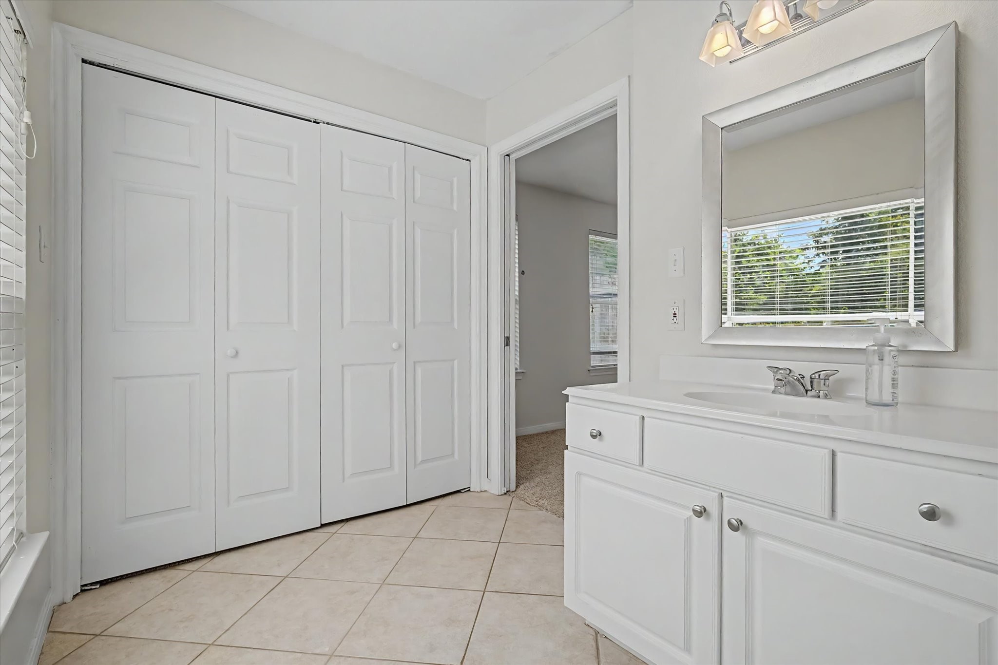 413 Farrer Street Angleton, TX 77515 - Photo 26 of 43 a bathroom with a sink and a mirror