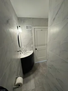 a kitchen with a refrigerator a sink and cabinets