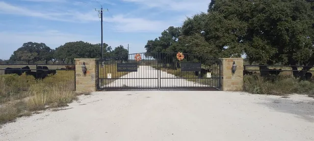 a backyard of a house with a garden and barbeque oven
