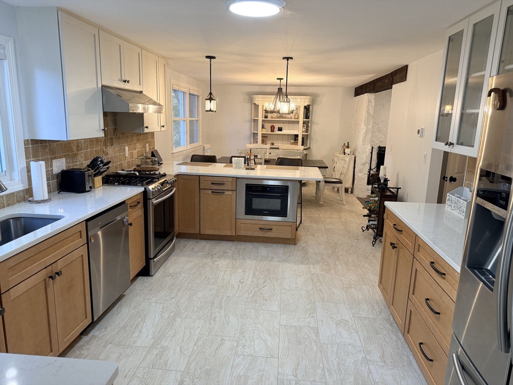 18 Boxford Road Topsfield, MA 01983 - Photo 12 of 37 a kitchen with stainless steel appliances granite countertop a stove a sink dishwasher and a refrigerator