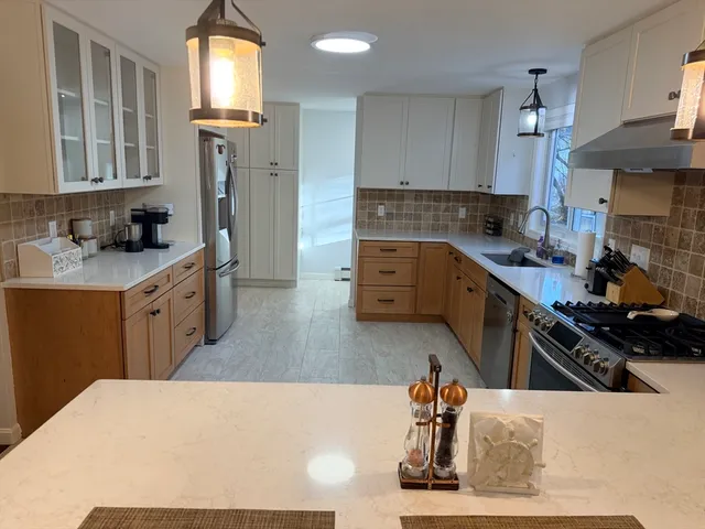 a kitchen with stainless steel appliances a sink stove and refrigerator