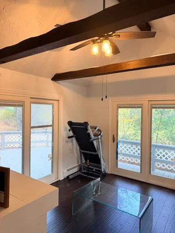 a room with wooden floor and furniture