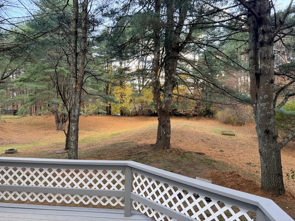 18 Boxford Road Topsfield, MA 01983 - Photo 7 of 37 a view of a yard with wooden fence and large trees