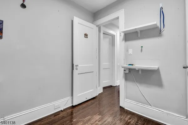 a view of a room with wooden floor