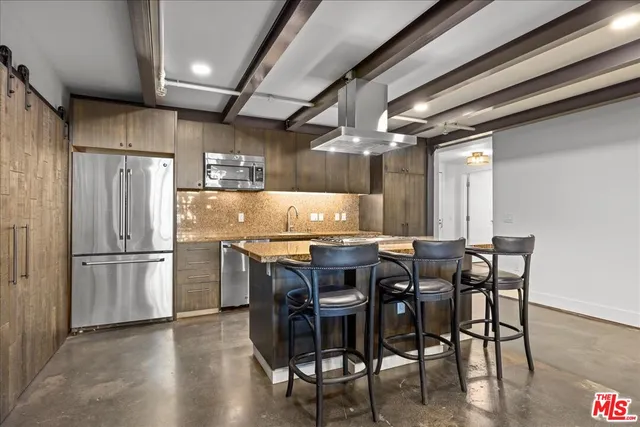 a kitchen with a wooden table and chairs