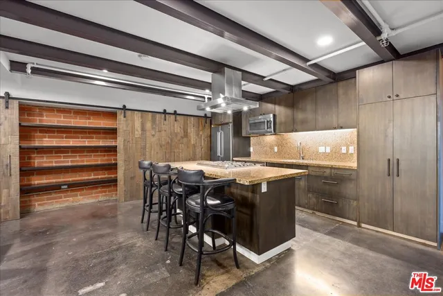 a kitchen with granite countertop a sink and stove