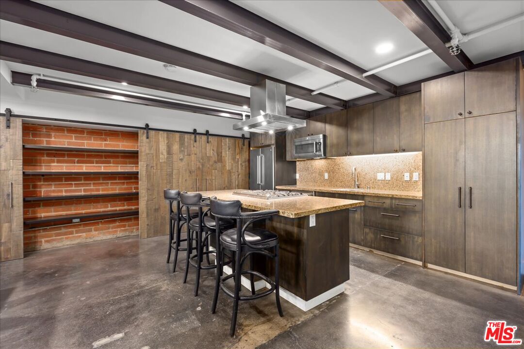 120 South Hewitt Street, Unit 6 Los Angeles, CA 90012 - Photo 14 of 48 a kitchen with a wooden table and chairs