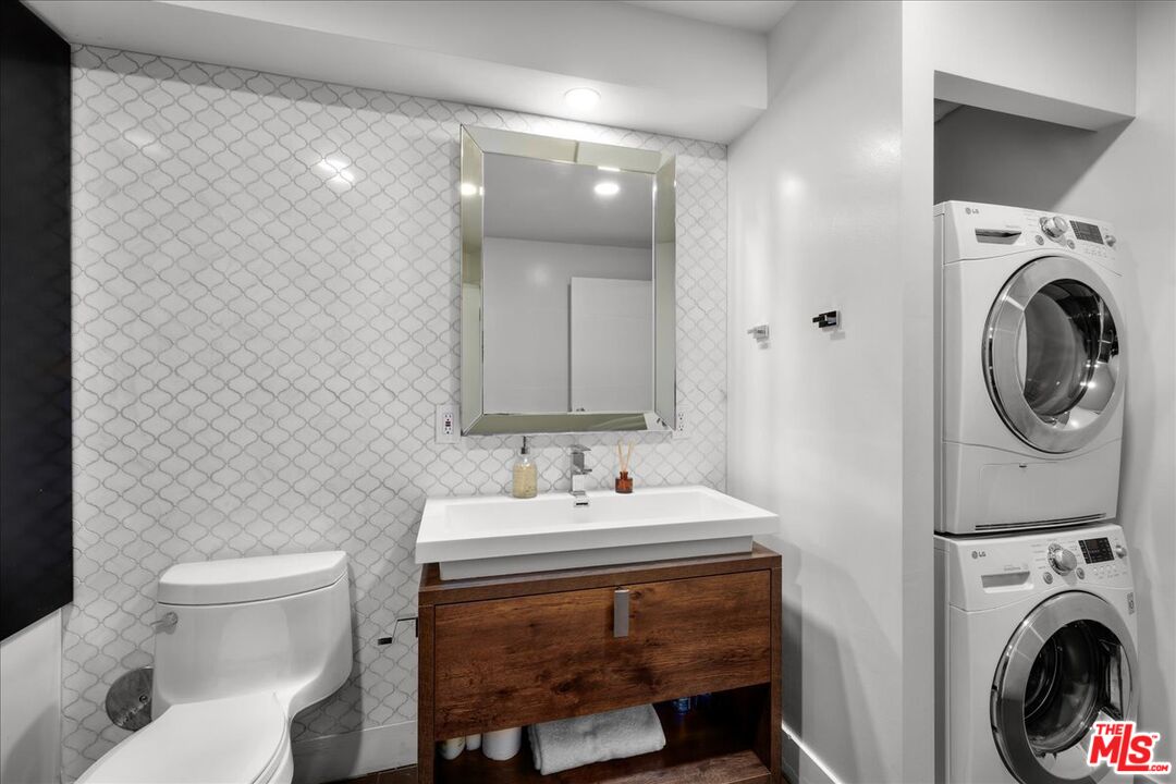 120 South Hewitt Street, Unit 6 Los Angeles, CA 90012 - Photo 19 of 48 a bathroom with a sink a toilet and a mirror