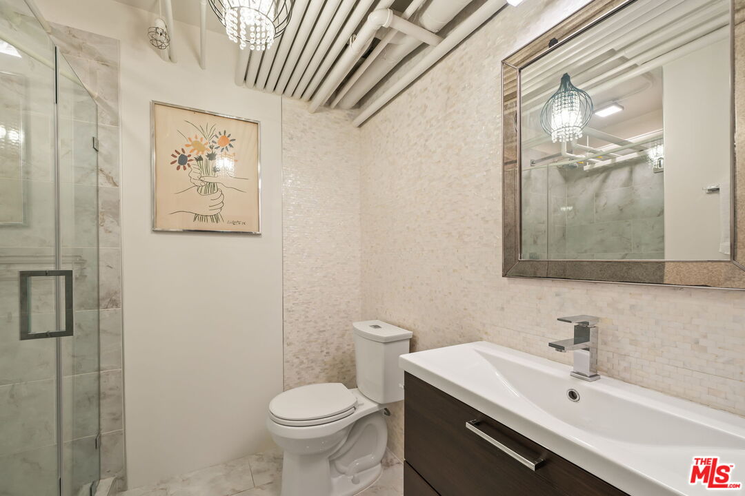 120 South Hewitt Street, Unit 6 Los Angeles, CA 90012 - Photo 30 of 48 a bathroom with a sink a toilet and shower