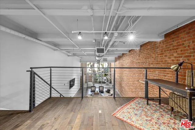 a building outdoor space with patio furniture and potted plants