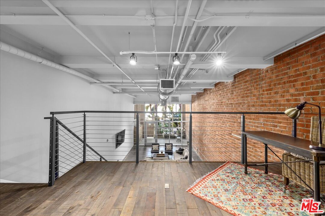 120 South Hewitt Street, Unit 6 Los Angeles, CA 90012 - Photo 33 of 48 a view of an empty room with wooden floor