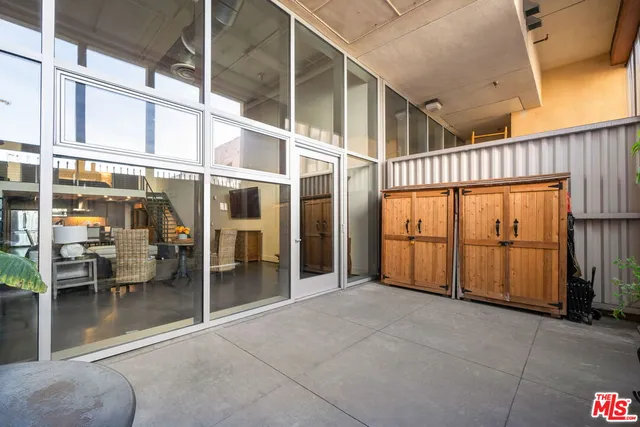 a view of a patio with table and chairs and potted plants