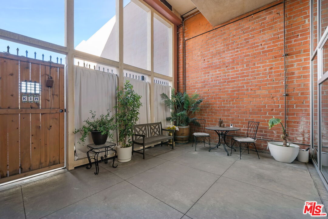 120 South Hewitt Street, Unit 6 Los Angeles, CA 90012 - Photo 38 of 48 a building outdoor space with patio furniture and potted plants