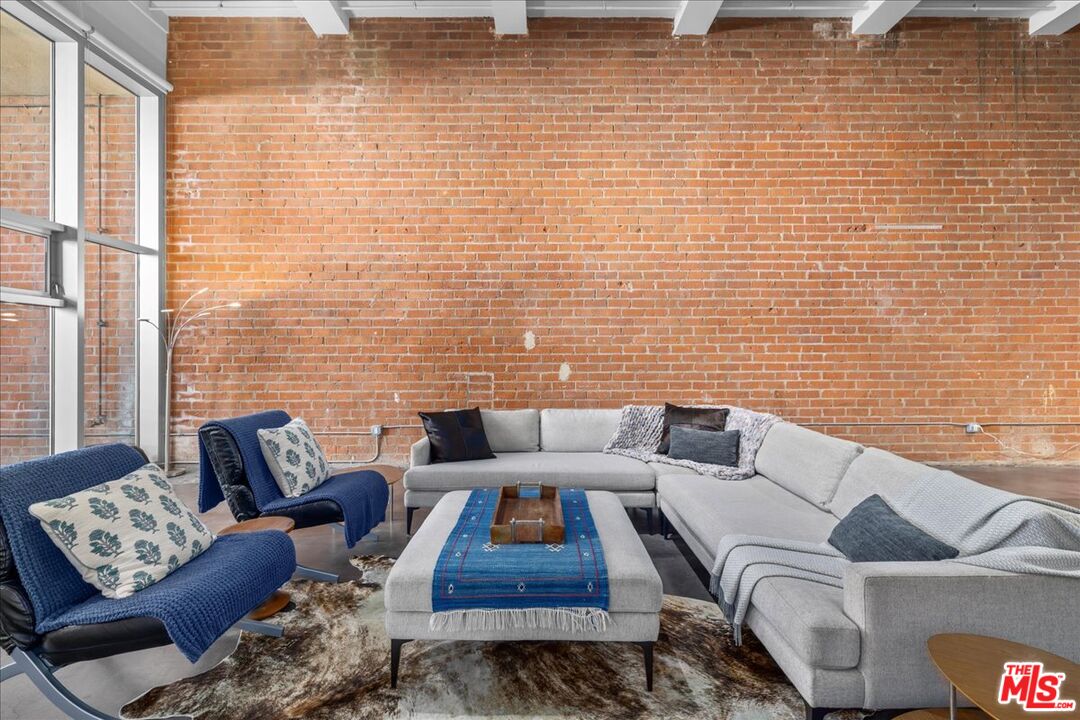 120 South Hewitt Street, Unit 6 Los Angeles, CA 90012 - Photo 4 of 48 a living room with furniture and a rug