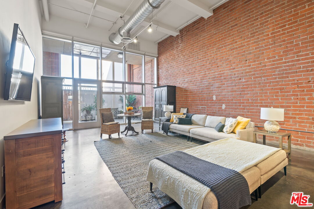 120 South Hewitt Street, Unit 6 Los Angeles, CA 90012 - Photo 5 of 48 a living room with furniture and large windows