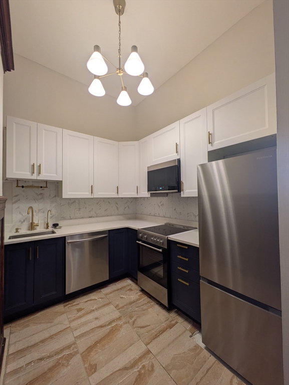 16 Balmoral Street, Unit 415 Andover, MA 01810 - Photo 1 of 4 a kitchen with stainless steel appliances granite countertop a refrigerator sink and cabinets