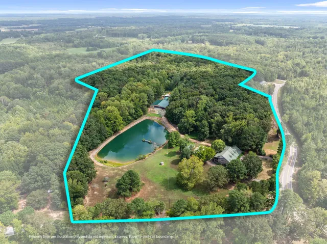 an aerial view of a house with a yard and lake view