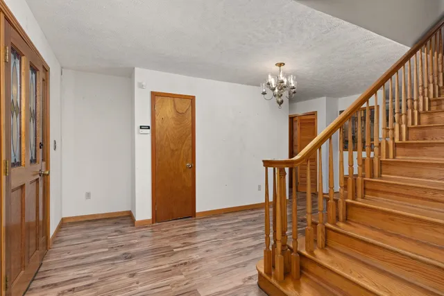 a spacious bathroom with a granite countertop sink a toilet and a mirror