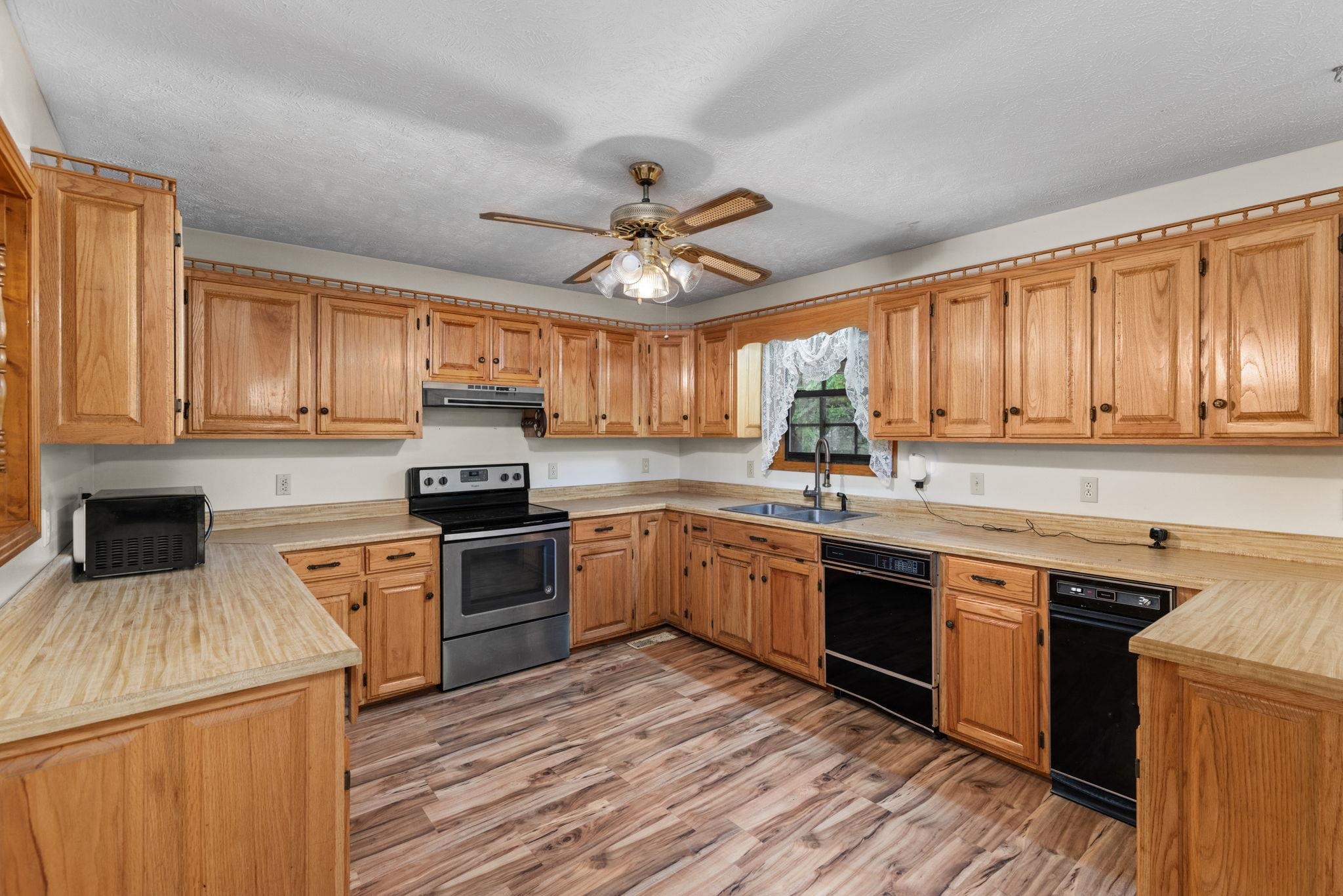 165 Highway 201 Reagan, TN 38368 - Photo 13 of 40 a kitchen with a stove cabinets and wooden floor