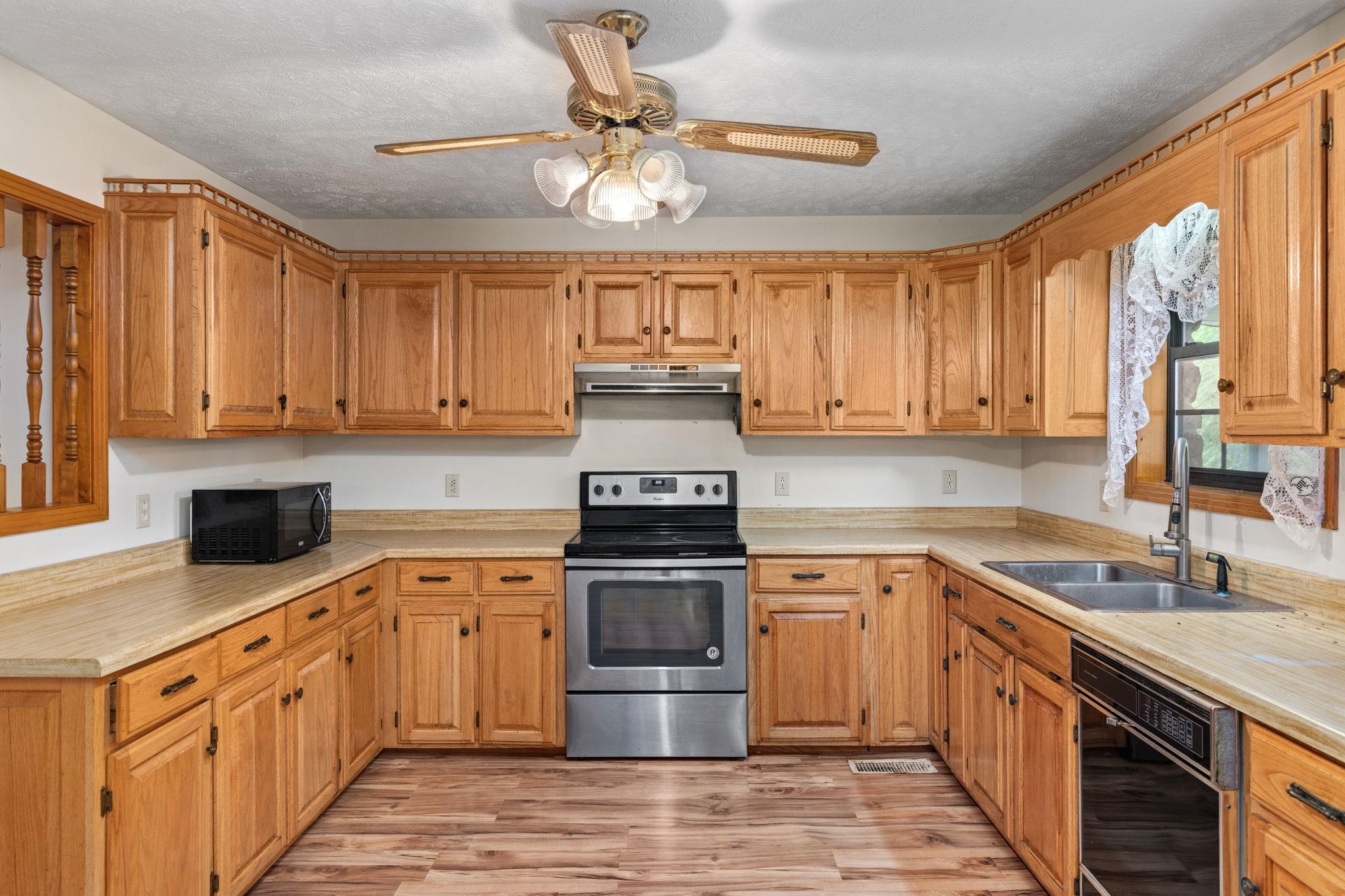 165 Highway 201 Reagan, TN 38368 - Photo 14 of 40 a kitchen with stainless steel appliances granite countertop a stove sink and cabinets