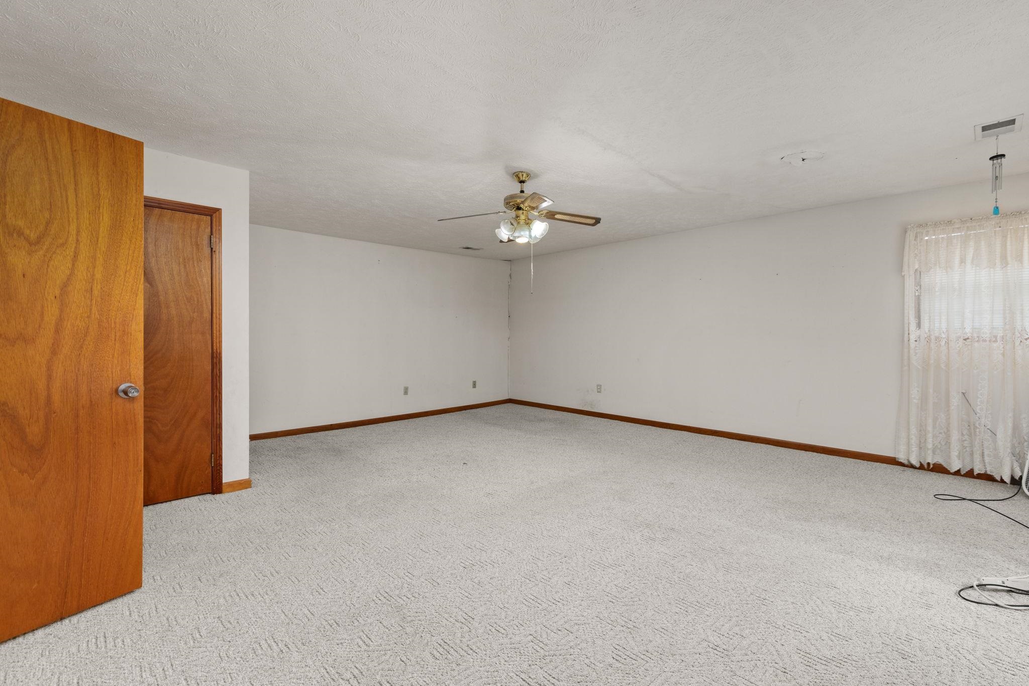 165 Highway 201 Reagan, TN 38368 - Photo 17 of 40 Unfurnished room featuring light carpet, a textured ceiling, and a ceiling fan