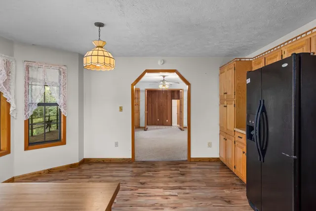 an empty room with a ceiling fan and window