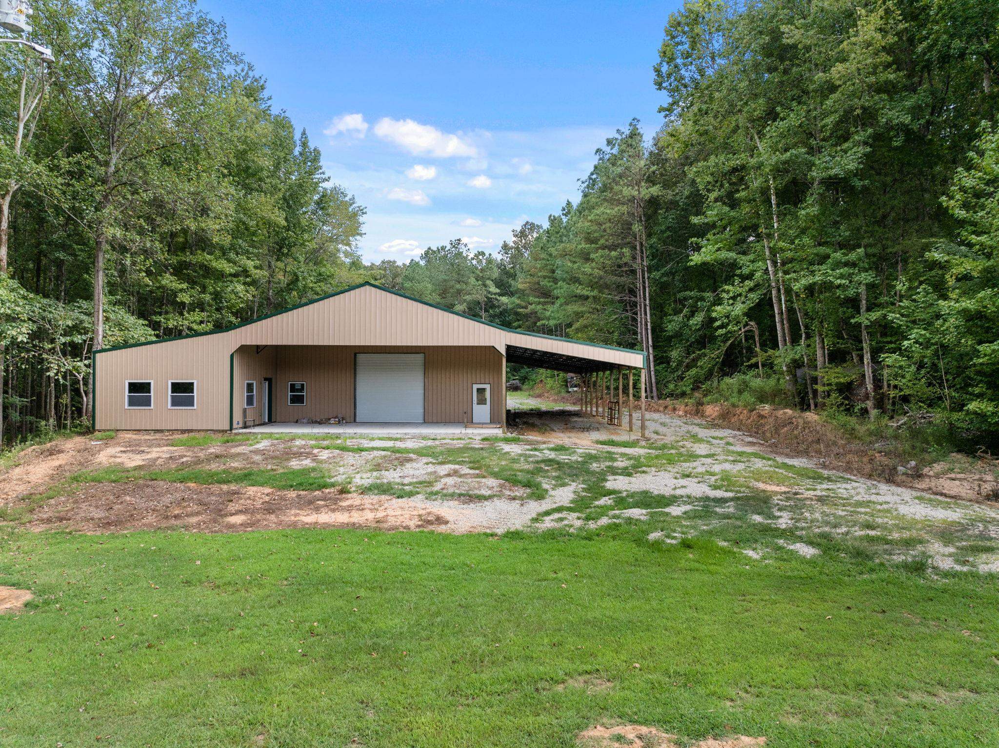 165 Highway 201 Reagan, TN 38368 - Photo 2 of 40 a backyard of a house with wooden fence and large trees
