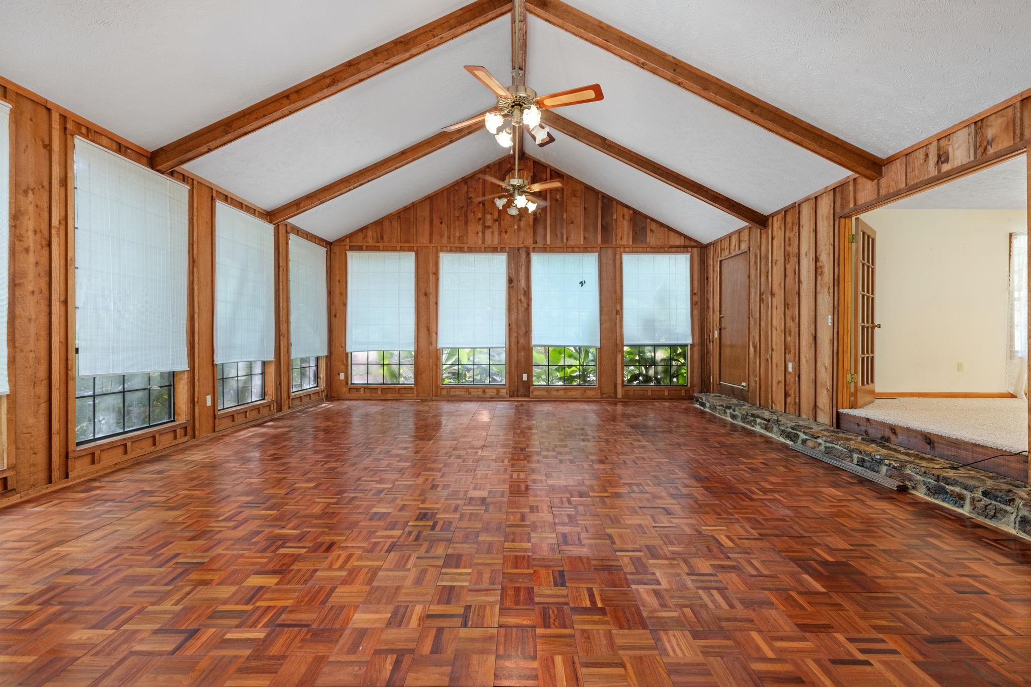165 Highway 201 Reagan, TN 38368 - Photo 29 of 40 Unfurnished living room featuring beam ceiling, wooden walls, high vaulted ceiling, and a ceiling fan