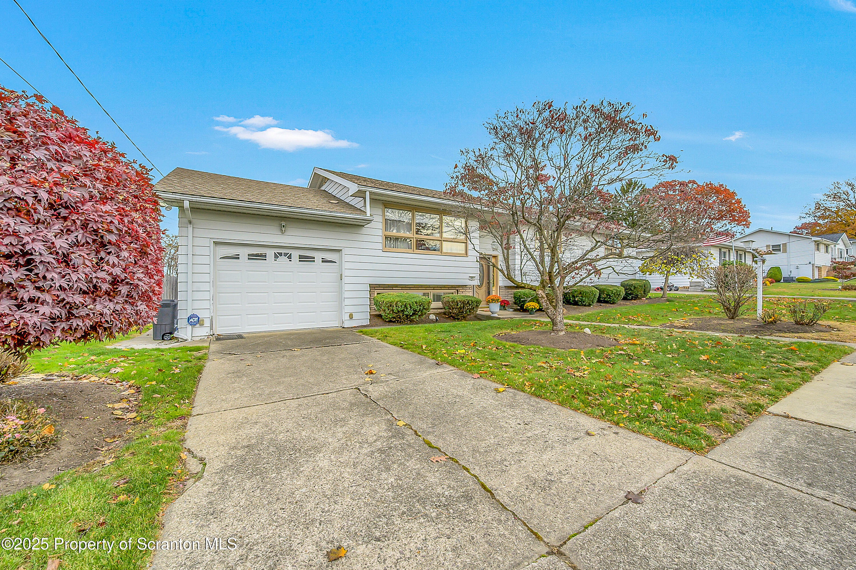 807 Marion Lane Moosic, PA 18507 - Photo 14 of 42 a front view of a house with a yard and garage