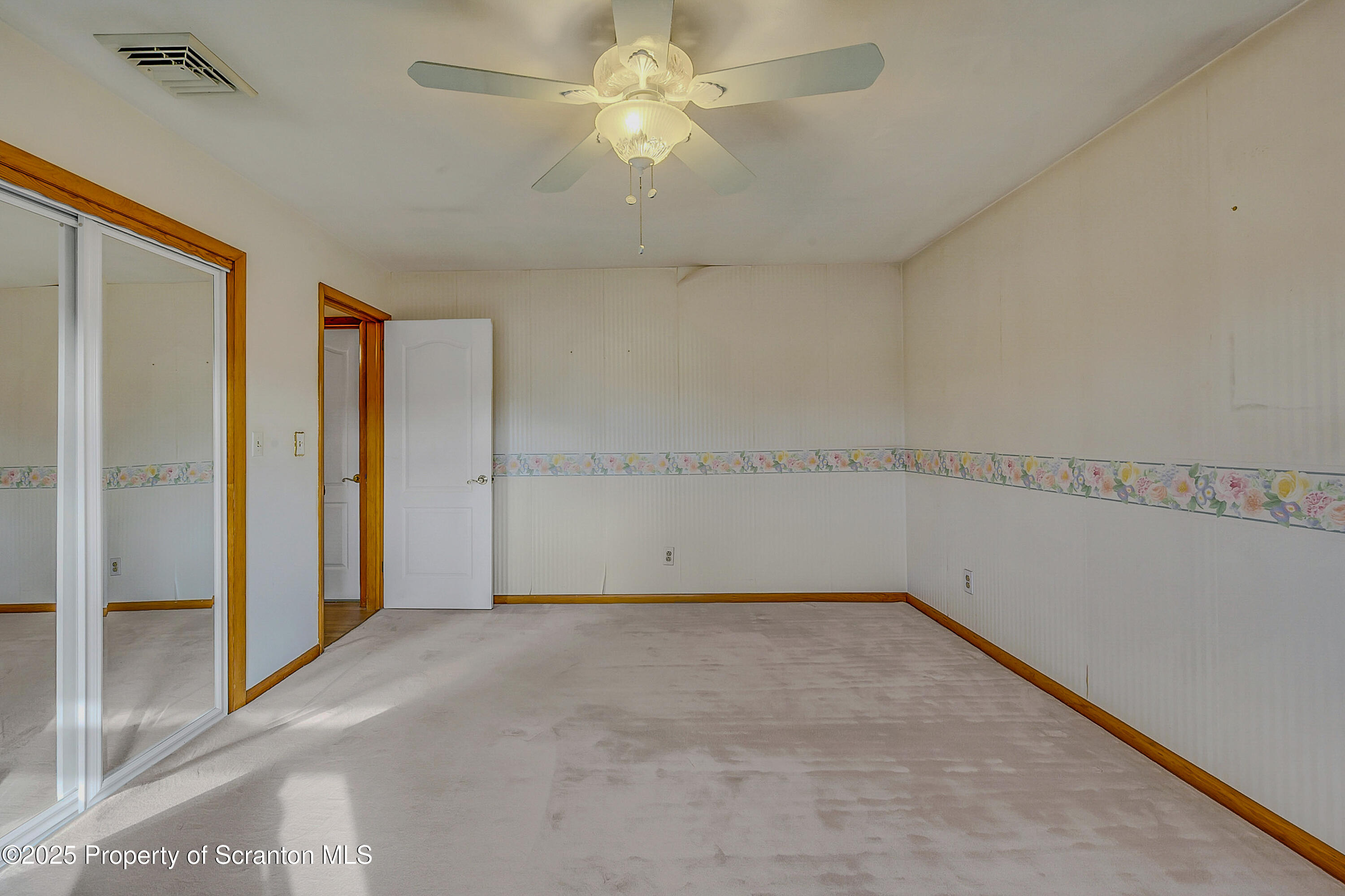 807 Marion Lane Moosic, PA 18507 - Photo 29 of 42 an empty room with a ceiling fan and glass door