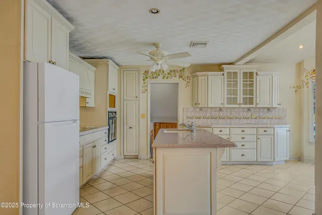 a bathroom with a granite countertop sink mirror and a shower
