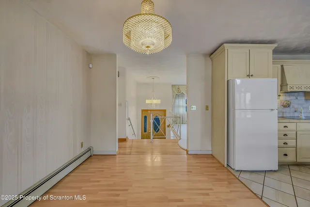 a view of a kitchen with an empty space and a window