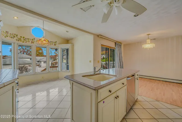 a spacious bathroom with a granite countertop sink and a mirror