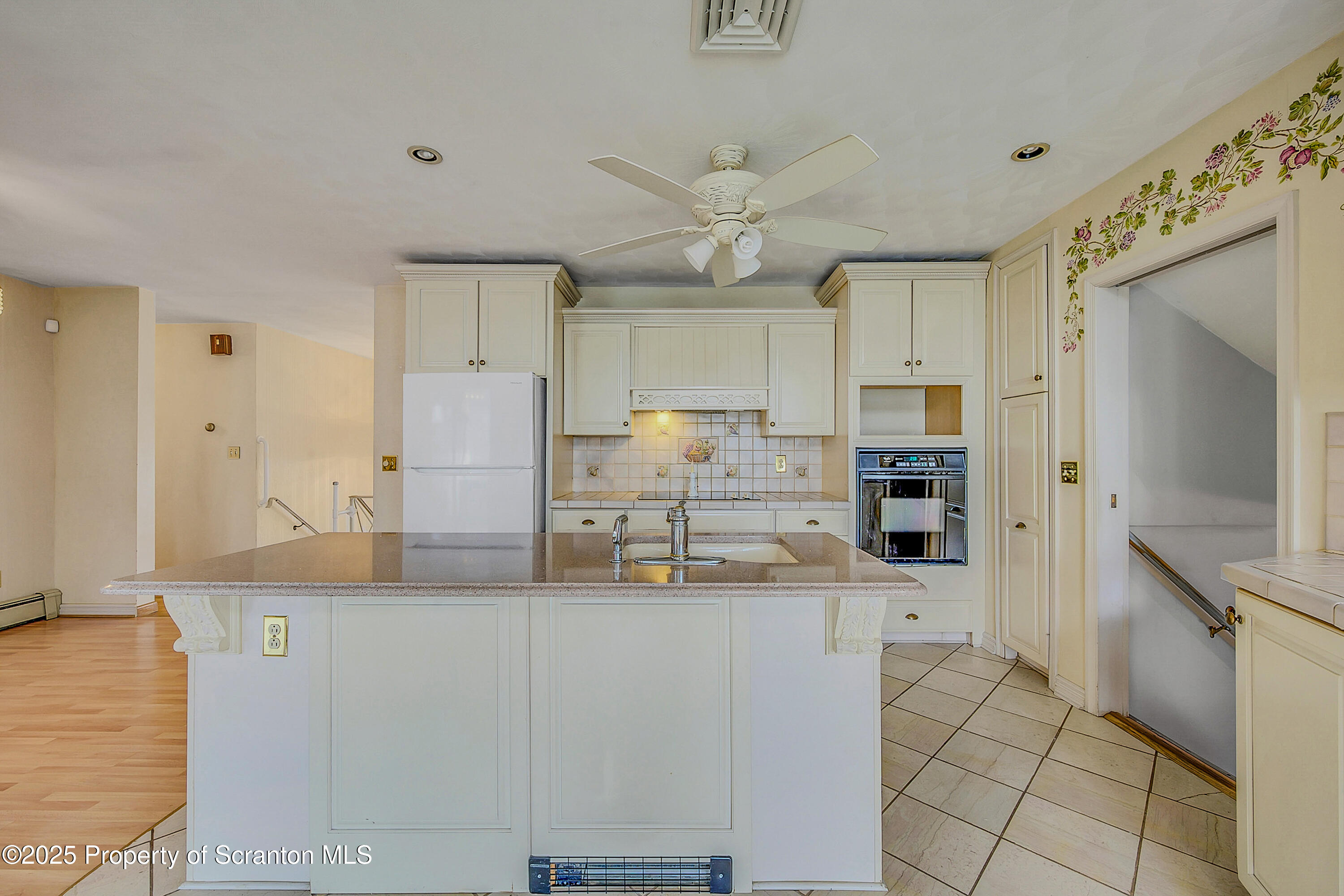 807 Marion Lane Moosic, PA 18507 - Photo 9 of 42 a kitchen with granite countertop a refrigerator and a stove top oven