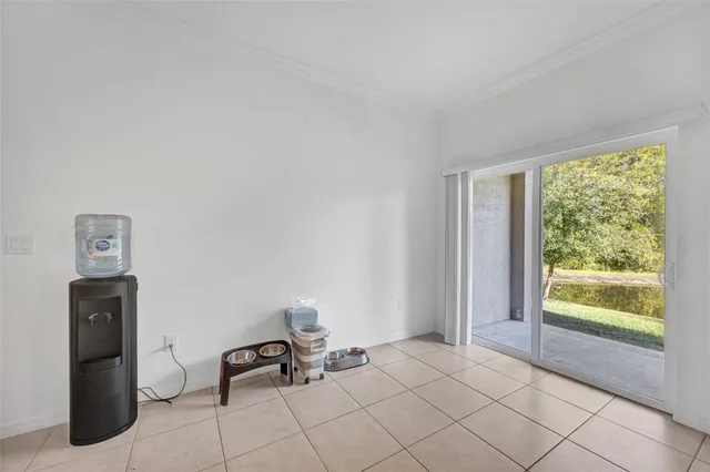 an empty room with wooden floor and fan
